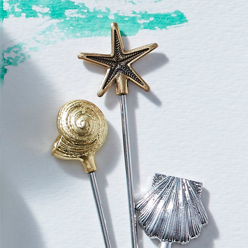 Joanna Buchanan | Cocktail Picks - Shell: Set of six elegant shell-design picks atop stainless steel and zinc, ideal for martinis or appetizers.