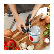 OXO Soft-Handled Can Opener in use, showcasing its ergonomic design with cushioned handles and oversized knob, ideal for effortless can opening in the kitchen.