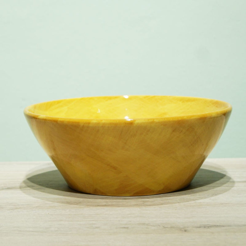 La Gabbianella | Pisa, Pasta Bowl, Yellow: A polished wood pasta serving bowl on a light wooden surface, part of the handmade “Corte” line from Italy.