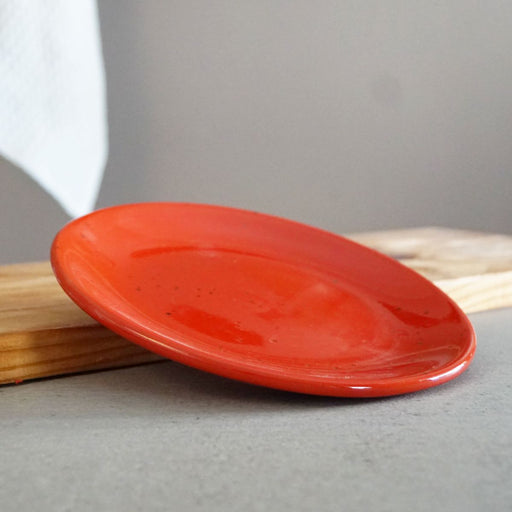 La Gabbianella | PISA, Salad/Dessert, Red plate in glossy ceramic, handcrafted in Italy, displayed on a wooden block against a neutral backdrop. Dishwasher and microwave safe.