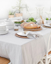 MagicLinen's 59 x 98-inch linen tablecloth with simple seam finish, ideal for versatile dining settings at Athens Cooks.