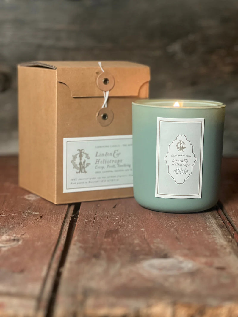 Lodestone Candles | Linden & Heliotrope Candle in a box, elegantly presented with a business card, showcasing its refined, botanical charm.