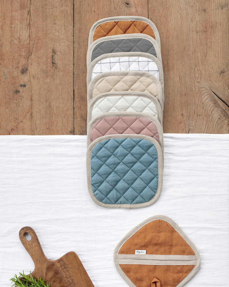 MagicLinen | Linen pot-holder in Woodrose, quilted with heat-insulating padding, displayed among other kitchen essentials, ideal for protecting hands while cooking.