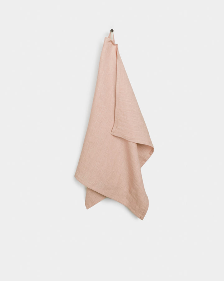 MagicLinen | Linen Tea Towels in Peach, hanging elegantly, showcasing its soft texture and versatile design, perfect for enhancing kitchen functionality and style.