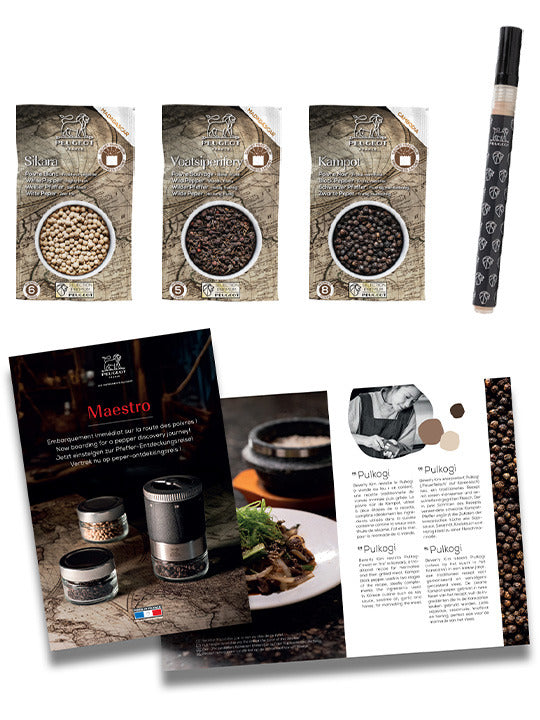 Peugeot Maestro Pepper Bar set featuring three premium pepper sachets, a pen-style mill, and a brochure, designed for culinary exploration and precision seasoning.