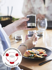 Peugeot Maestro Pepper Bar with switchable jars in use, alongside fresh pasta, showcasing its precision engineering and versatility for culinary exploration.