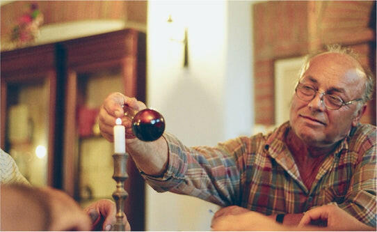 Man holding Acetaia Leonardi 16 Year Balsamic Vinegar bottle, highlighting its artisanal craftsmanship and single-ingredient purity, emphasizing the product's authenticity and traditional Italian heritage.