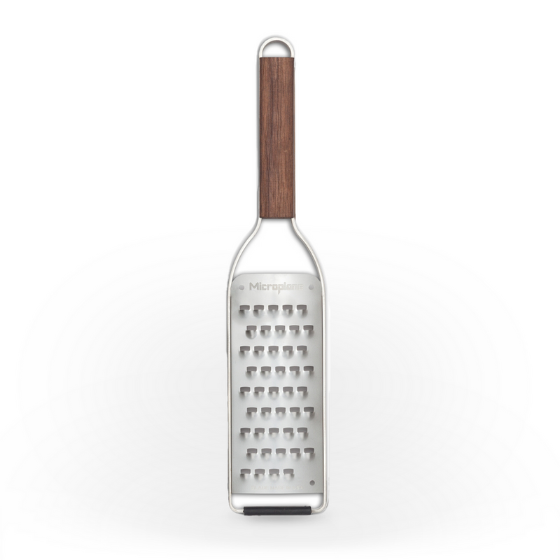 Microplane | Master Series Extra Coarse Grater with Walnut Handle, featuring a stainless-steel surface, wooden handle, rubber bumper, ideal for zesting and grating various ingredients.