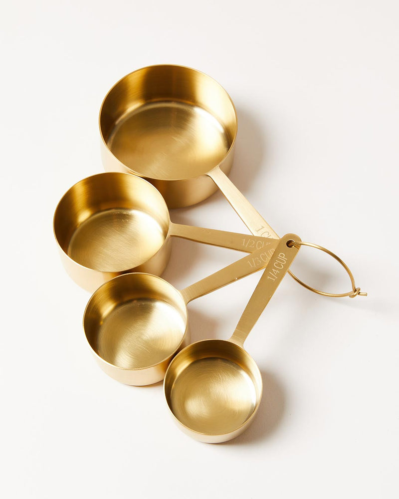 Farmhouse Pottery | Stowe Measuring Cups: Set of four brushed gold metal cups with standard measures, elegantly designed for precise baking and cooking.