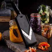 Microplane | Adjustable V-Blade Mandoline Slicer on a slate board with sliced vegetables and jars of pickled produce, highlighting its precision slicing capabilities.