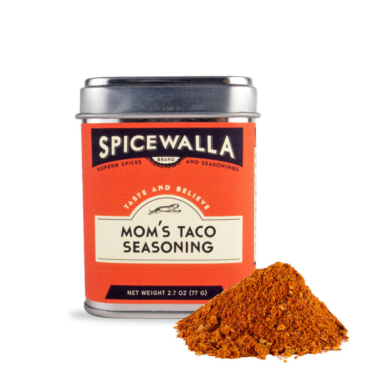 Spicewalla | Mom's Taco Seasoning tin with seasoning pile in front, ideal for enhancing tacos and more with a slightly spicy, perfectly seasoned flavor.
