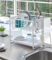 Yamazaki Home | Two-Tier Dish Rack - White, featuring a compact, adjustable design with a plastic tray and utensil holder, ideal for maximizing kitchen counter space.