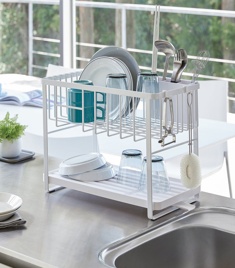 Yamazaki Home | Two-Tier Dish Rack - White, featuring a compact, adjustable design with a plastic tray and utensil holder, ideal for maximizing kitchen counter space.