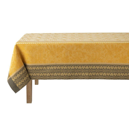 Le Jacquard Francais Gipsy Tablecloth in yellow, featuring a damask floral pattern with gray tulip motif border, adds bohemian elegance to any kitchen setting.