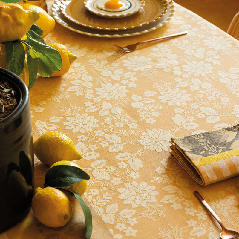 Le Jacquard Francais | Gipsy Tablecloth, Yellow, 69 x 98, elegantly draped with fresh lemons, plates, and cutlery, creating a vibrant, summery tabletop scene.