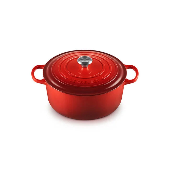 Le Creuset Signature Oval Dutch Oven, 8 QT, Cerise, featuring side handles and a snug lid for excellent heat retention and moisture trapping, ideal for cooking.