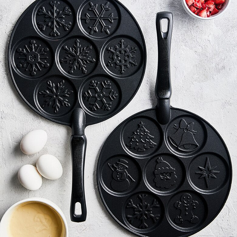 Nordic Ware | Holiday Pancake Pan featuring festive designs, including tree and snowman shapes, ideal for creating seven perfectly cooked pancakes at once.