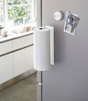 Yamazaki Home Magnetic Steel Paper Towel Holder on fridge door, with kitchen timer and photo magnets, in a modern kitchen.