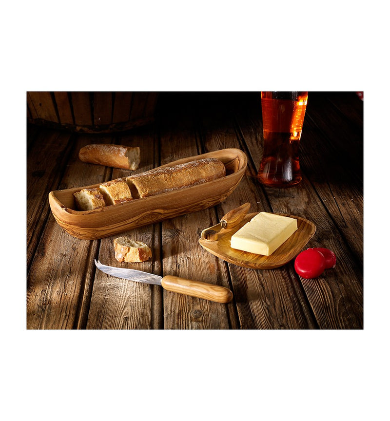 BERARD | Bread Basket 13.75/35cm Olivewood displayed with a loaf of bread, butter, and a knife, highlighting the basket's rustic elegance and utility.