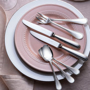 Christofle | 5-Piece Place Setting Perles Silver Plated on elegant china, showcasing refined craftsmanship with a classic beaded rim and polished finish, ideal for sophisticated dining.
