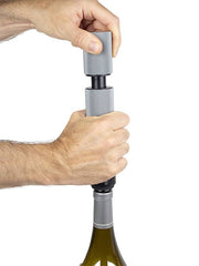 Peugeot | Preserve Duo - Carbon is used to open a bottle of wine, showcasing its functionality in enhancing wine preservation and serving.