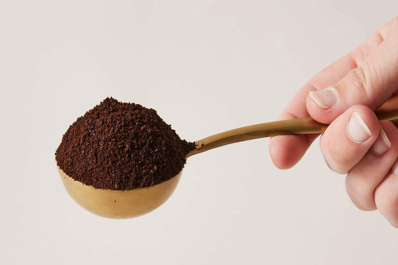 Essex Coffee Scoop by Farmhouse Pottery, featuring a scalloped handle and brushed gold finish, designed to hold 2 tablespoons for precise coffee or tea measurement.