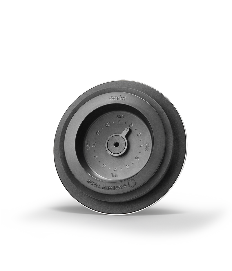 Aarke | Purifier Pure Water Filter Pitcher, a round metal object, designed for clean tap water with refillable steel filter cartridge and granules.