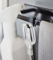 Yamazaki Home | Magnetic Kitchen Towel Hanger, Steel, White, holds a spray bottle and cloth on a rail, showcasing efficient kitchen organization.