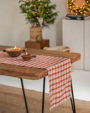 MagicLinen's red gingham linen table runner, 16 x 79, enhances festive dining, embodying Athens Cooks' dedication to quality kitchen elegance.