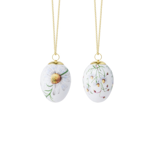 Royal Copenhagen | Spring 2026 Eggs Chamomile 6cm 2pc, featuring hand-painted daisy motifs on porcelain, suspended by gold cords, perfect for springtime decoration.