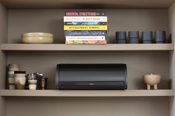 Brabantia USA Inc | Roll Top Bread Box in Confident Gray on a kitchen shelf, designed for efficient bread storage with a space-saving roll-top lid.