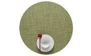 Chilewich | Mini Basketweave Round Placemats enhance dining with a refined texture, shown here with a white bowl and red spoon. Ideal for any table setting.