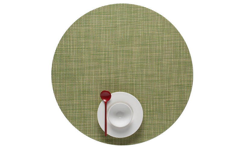 Chilewich | Mini Basketweave Round Placemats enhance dining with a refined texture, shown here with a white bowl and red spoon. Ideal for any table setting.