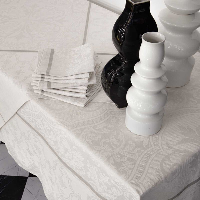 Le Jacquard Francais | Armoiries Linen Napkin, Offwhite, elegantly folded on a damask-patterned tablecloth, showcasing exquisite craftsmanship and French heritage.