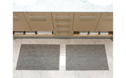 Chilewich | Heathered Shag Mats in Grey, 24 x 36, on a bathroom counter with two rugs, combining durability with a plush look for versatile home use.