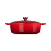 Le Creuset | Signature Round Wide Oven, Cerise: Red enameled cast-iron Dutch oven with lid and handles, ideal for versatile cooking, from stove to table.