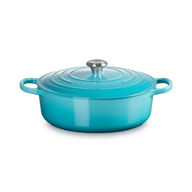 Le Creuset | Signature Round Wide Oven - Caribbean, a versatile, teal enameled cast-iron Dutch oven with side handles and lid, ideal for braising and roasting.