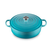 Le Creuset | Signature Round Wide Oven - Caribbean: A turquoise enameled cast-iron Dutch oven with lid and handles, ideal for versatile cooking tasks, from searing to serving.