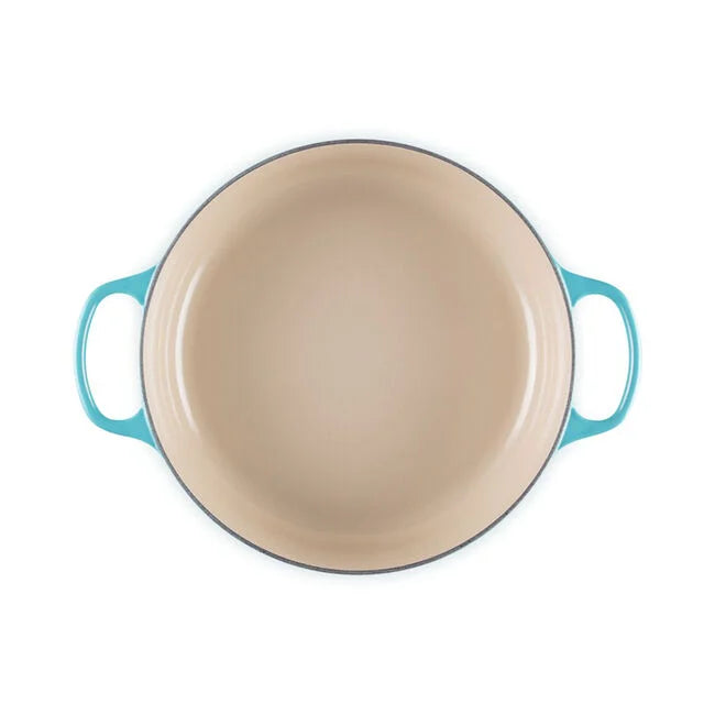 Le Creuset | Signature Round Wide Oven - Caribbean, viewed from above, showcasing its wide, light interior and two handles, ideal for versatile cooking and serving.