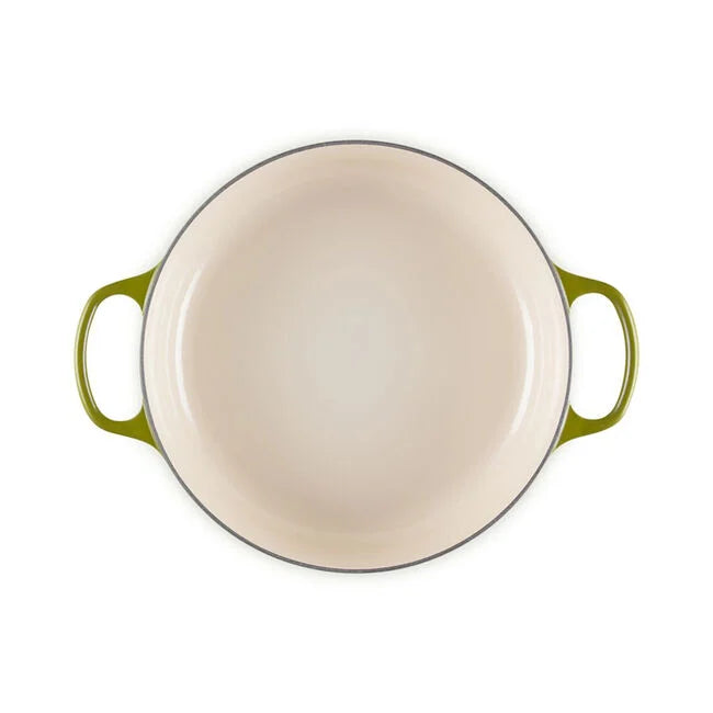 Le Creuset | Signature Round Wide Oven - Olive: Top-down view of an empty, enameled cast iron casserole with loop handles, ideal for versatile cooking and serving.