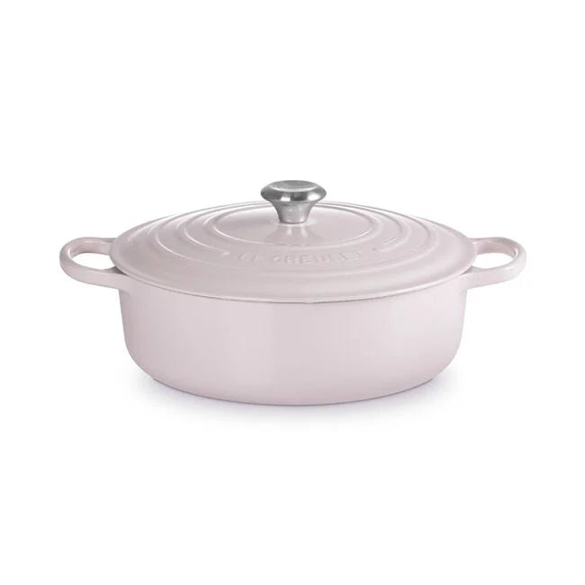 Le Creuset | Signature Round Wide Oven - Shallot, an oval enameled cast-iron Dutch oven with lid and side handles, ideal for versatile cooking and easy serving.