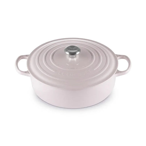 Le Creuset | Signature Round Wide Oven - Shallot, a pastel pink enameled cast-iron Dutch oven with side handles and a fitted lid, ideal for versatile cooking.