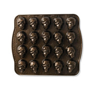 Nordic Ware | Skull Cakelet Pans - Skull Bites: Dark non-stick pan with 20 skull-shaped cavities for creative treats like mini cakes or candies.