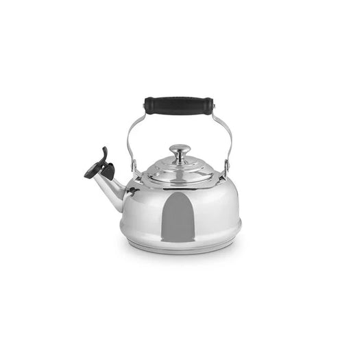 Le Creuset Classic Whistling Kettle, Stainless Steel, featuring a hinged black handle and spout cover, ideal for stovetop use, available at Athens Cooks kitchen store.
