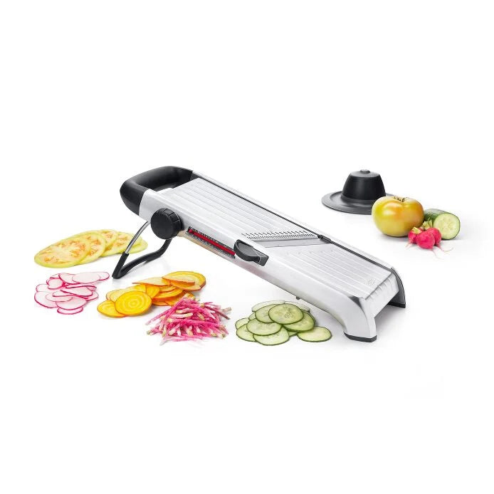 OXO Chef's Steel Mandoline displayed with sliced vegetables, showcasing its precise slicing capability, perfect for enhancing culinary preparations from Athens Cooks.