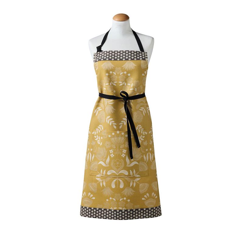 Le Jacquard Francais | Féerie Apron, Yellow, with folk-style motif and star accents, displayed on a dress form. Features adjustable ties and a pocket.