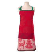 Le Jacquard Français | Lumiere D'Etoiles Apron on a dress form, featuring red fabric, green straps, holiday motifs of reindeer and fir trees.