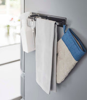 Yamazaki Home Magnetic Kitchen Towel Hanger in use, holding kitchen tools and towel, magnet-mounted for easy access, ideal for organizing your kitchen essentials efficiently.