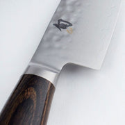 Shun Premier Utility 6.5 Walnut knife with hammered tsuchime finish, Damascus pattern, and dark wood handle, ideal for precise kitchen tasks.