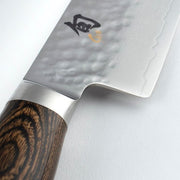 Shun Premier Chef's Walnut 8-inch knife with a hammered stainless-steel blade, Damascus pattern, and octagonal wooden handle, ideal for precise slicing and chopping.